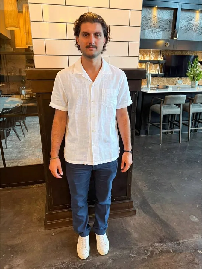 Virtual try-on of a white linen camp shirt on a second person